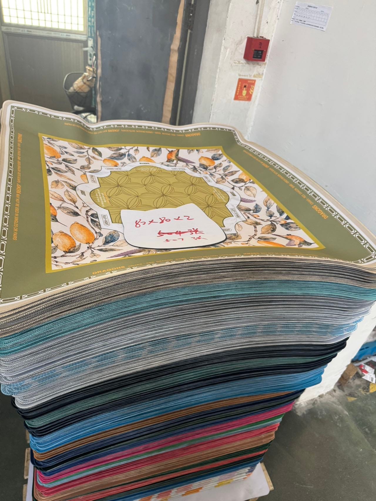 Printed mat samples stacked for product review